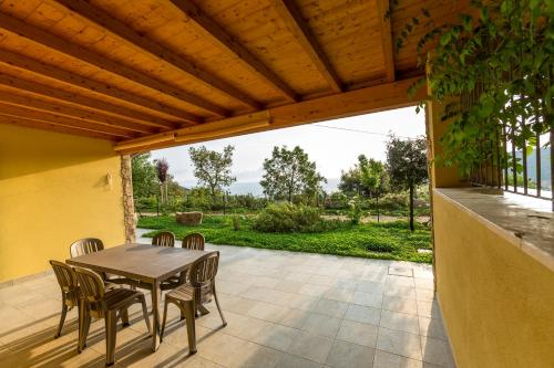 a patio with a table and chairs on a patio at Borgo dell'Uccellaia - Smeraldo in Marciana Marina