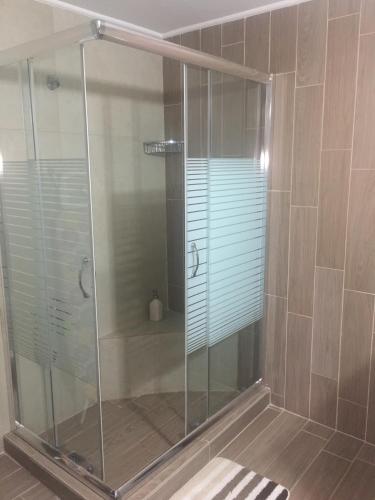 a shower with a glass enclosure in a bathroom at Maria's Garden in Galatás