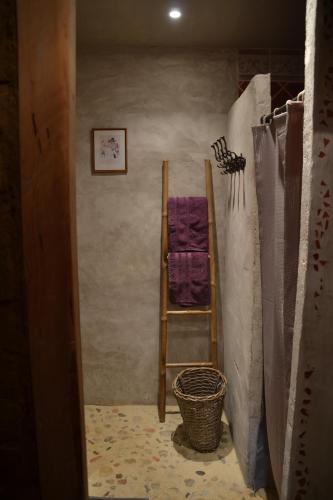 a ladder in a room with a towel on the wall at La Voureyline in Saint-Antoine