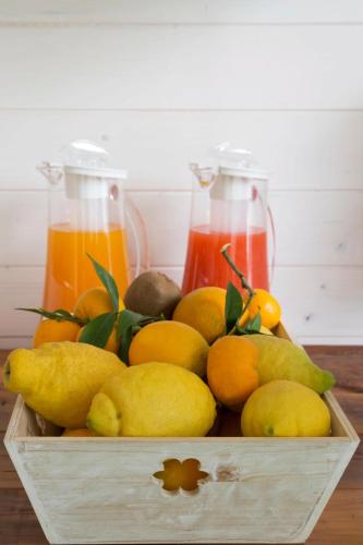 a wooden box filled with lemons oranges and juice at Townhouse Tropea in Tropea