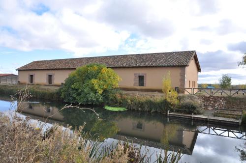 a building next to a body of water at Carrecalzada in Melgar de Fernamental