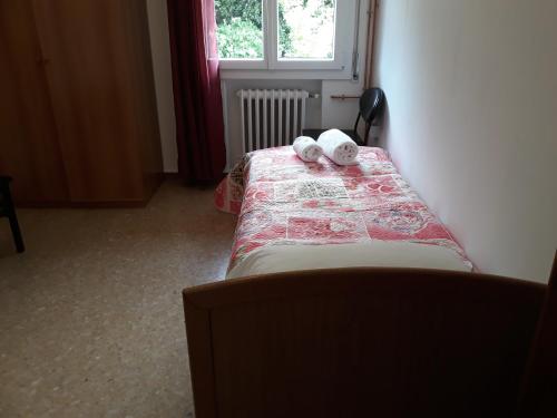 a bedroom with a bed with two towels on it at Venice Best Vacation in Marghera