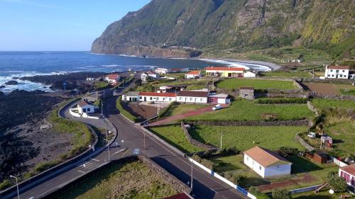 a small town on a hill next to the ocean at Casa do Baixio in Faja Grande