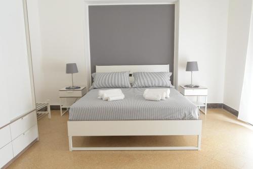 a bedroom with a bed with two pillows on it at Caselita in Palermo