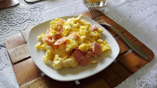a plate of scrambled eggs with ham on a table at Alojamiento Familiar Villa Palmeras in Tarapoto