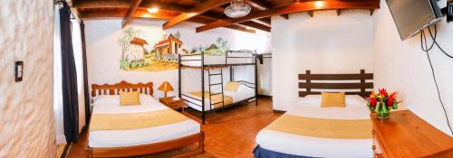 Postel nebo postele na pokoji v ubytování Hotel Flor Blanca