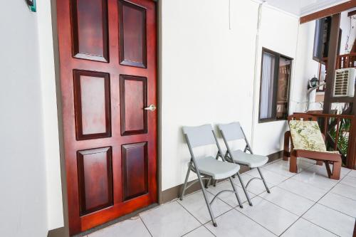 a group of chairs sitting in front of a door at Hotel Flor Blanca in Manuel Antonio
