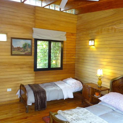 a room with two beds and a window at LA AGÜITA PERDIDA in Raco