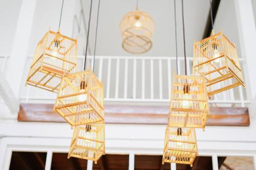 a group of wicker baskets hanging from a ceiling at Memmoth Hostel In Lampang in Lampang