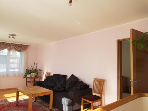 a living room with a couch and a table at Viru Maja in Tallinn