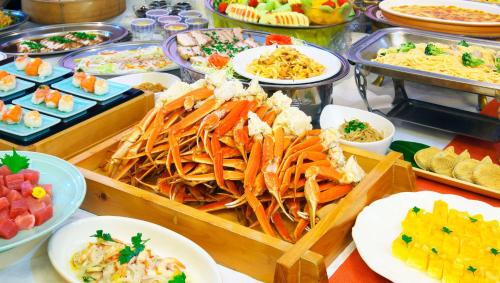 a buffet with many different types of food on a table at Kasugai View Hotel in Fuefuki