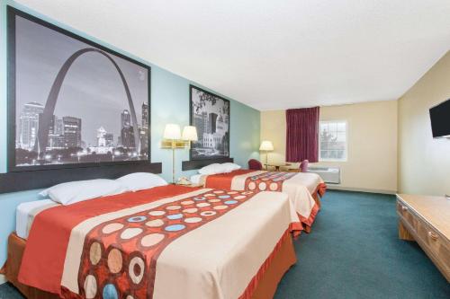 a hotel room with two beds and a large window at Super 8 by Wyndham Carthage in Carthage