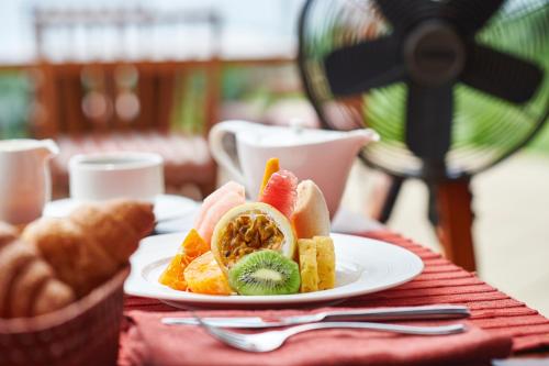 a plate of fruit and bread on a table at Cape Weligama - Relais and Chateaux in Weligama