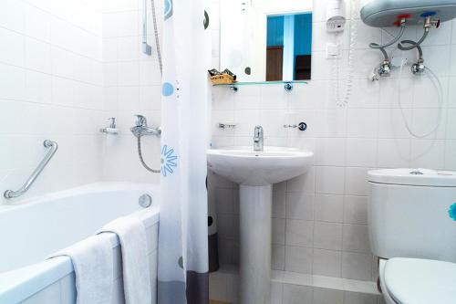 a bathroom with a toilet, sink, and tub at Boutique Hotel Ioann Vasilievich in Yaroslavl