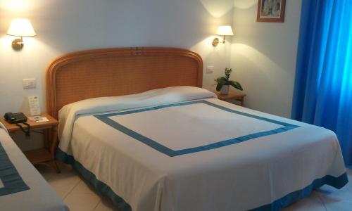 a hotel room with two beds and a lamp at Hotel Del Levante in Torre Canne