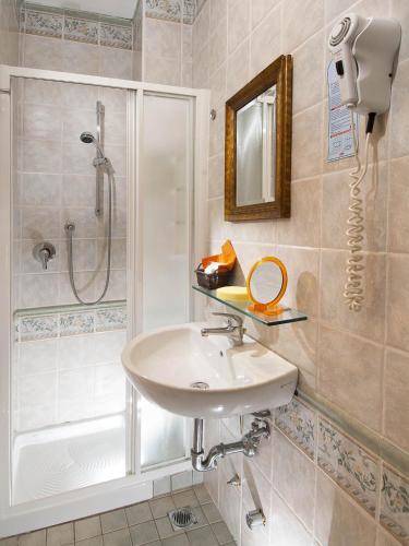a bathroom with a sink and a shower at Hotel Negresco in Milano Marittima