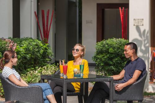 a group of people sitting at a table at Almanity Hoi An Resort & Spa in Hoi An