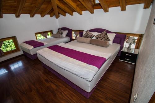 a bedroom with a large bed and a couch at Pansion Oscar Summer Garden in Mostar
