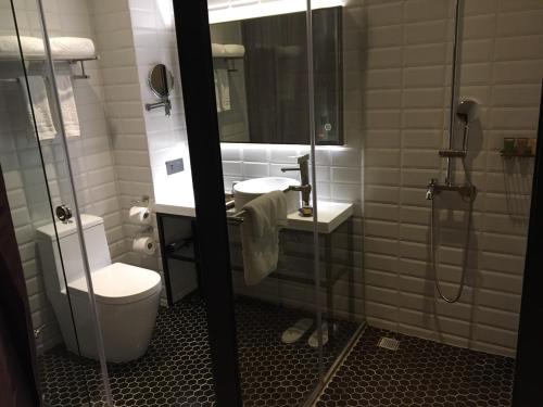 a bathroom with a toilet and a sink and a shower at City Suites - Beimen in Taipei