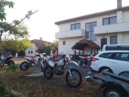 a group of motorcycles parked in front of a building at Pensiunea Aurelia in Şiria