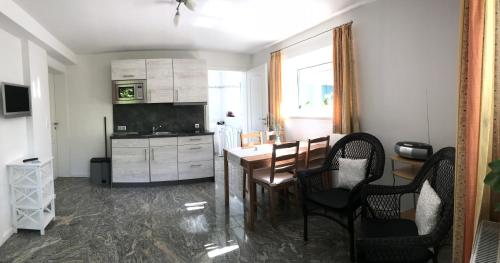a kitchen with a table and chairs in a room at Haus Sonnenschein in Timmendorfer Strand