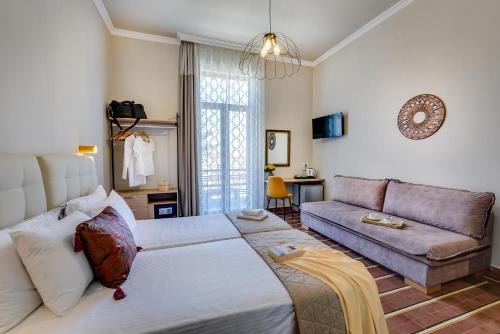 a living room with a bed and a couch at Mosaic in Chania