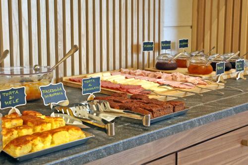 a buffet with different types of meats and other food at Hotel Garden in Peschiera del Garda