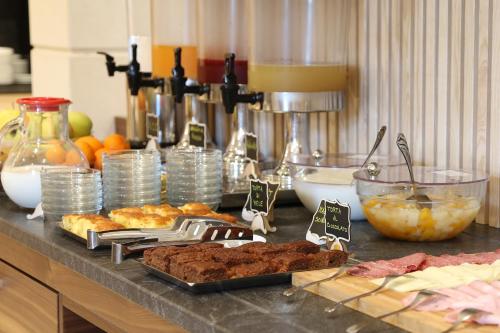 a counter top with food and other foods on it at Hotel Garden in Peschiera del Garda
