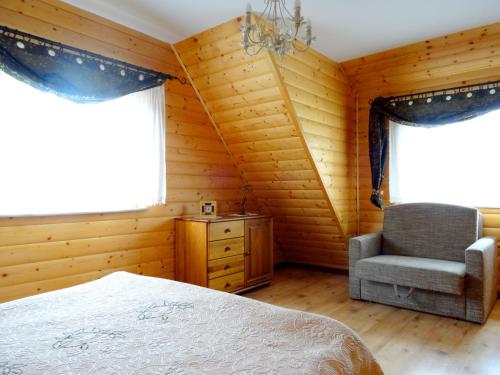 sypialnia z łóżkiem, krzesłem i oknem w obiekcie Dom Derbend na wyłączność w Sztutowie