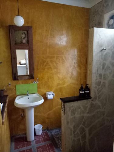a bathroom with a sink and a shower at Baan Jaru in Chiang Rai