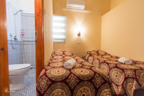 a bathroom with a bed and a shower and a toilet at Daher Guest House Nazareth in Nazareth
