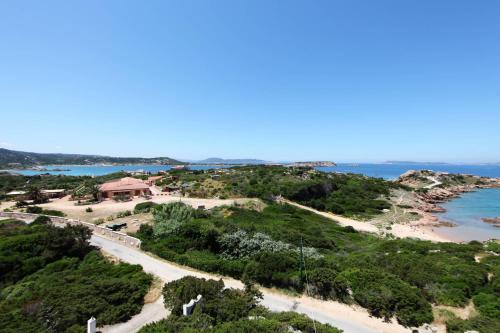 a scenic view of a beach with palm trees at Residenza Marginetto in La Maddalena