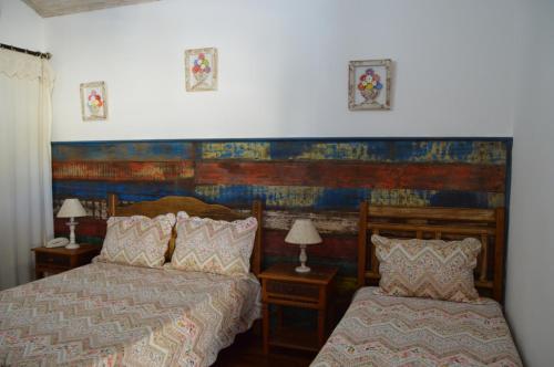 a bedroom with two beds next to each other at Pousada Berço da Liberdade in Tiradentes