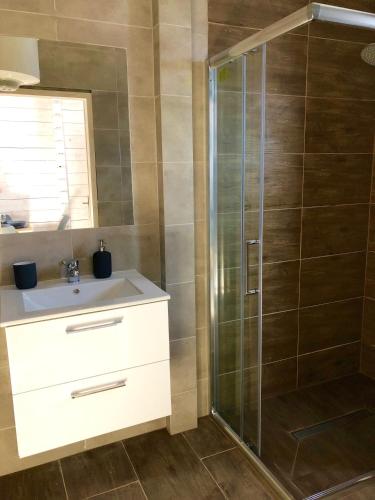a bathroom with a shower and a sink at Sarbinówka23 in Sarbinowo