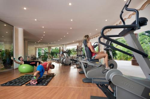 a group of people exercising in a gym at Hotel Marinedda Thalasso & Spa in Isola Rossa