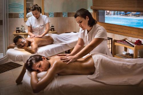a woman getting a massage in a spa salon at Hotel Marinedda Thalasso & Spa in Isola Rossa