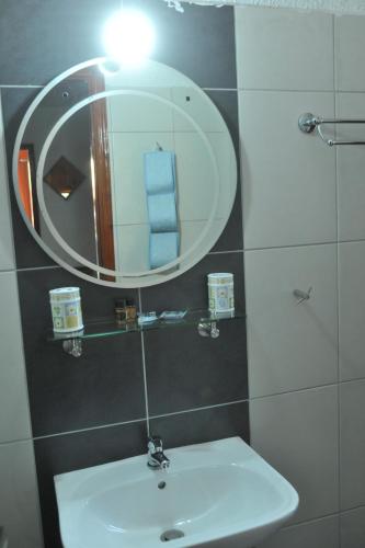 a bathroom with a sink and a mirror at Chaliotis Apartments in Lefkandi Chalkidas