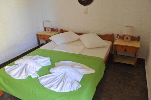 a bedroom with a bed with towels on it at Chaliotis Apartments in Lefkandi Chalkidas