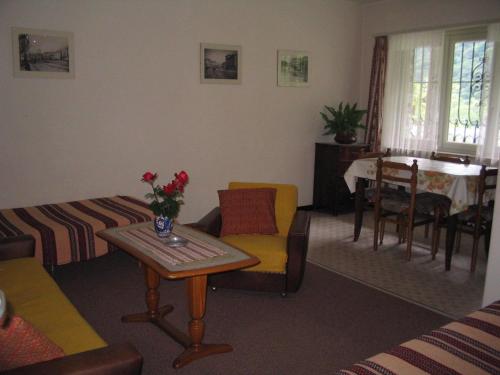 a living room with a table and a dining room at Casa Giada in Avegno