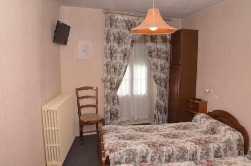 Postel nebo postele na pokoji v ubytování Hotel du Commerce