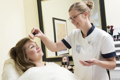 a woman in a salon getting her hair cut at Maritim Seehotel Timmendorfer Strand in Timmendorfer Strand