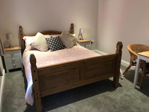 ピーターズフィールドにあるMays Cottage Bed and Breakfastのベッドルーム1室(木製ベッド1台、枕付)