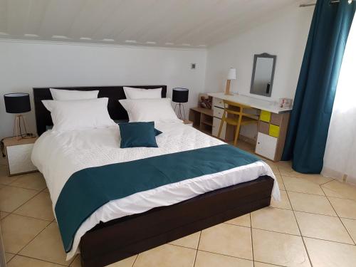 a bedroom with a large bed with a mirror at T2 avec accès piscine SUD- OUEST de la Réunion in Les Cocos