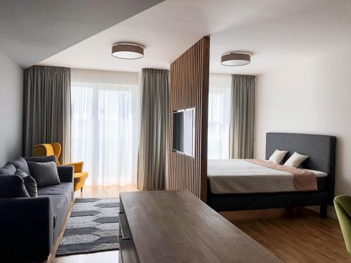 a hotel room with a bed and a couch at Apartment DOWNTOWN in Brno