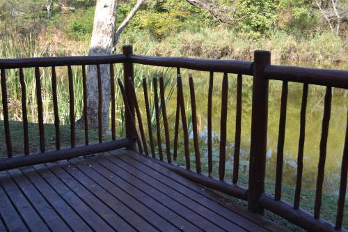 a wooden bench sitting on top of a fence at Kruger Park Lodge - Golf Safari SA in Hazyview