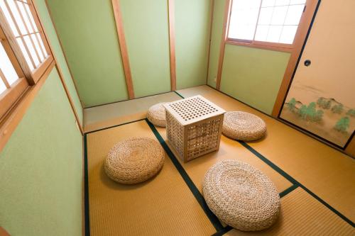 a corner of a room with stools and a window at Sano-san-chi in Izumi-Sano