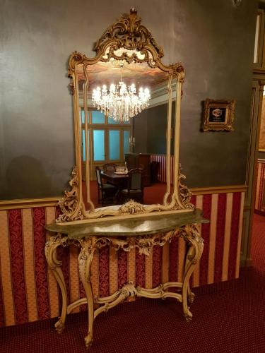 a large mirror on a table in a room at NF Palace Old City Bucharest in Bucharest