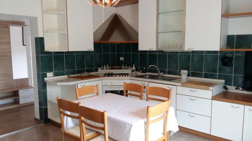 a kitchen with a table and chairs and a sink at KEI apartment in Portorož