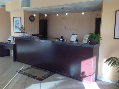 a lobby with a large counter in a room at Travelers Lodge Beatrice in Beatrice