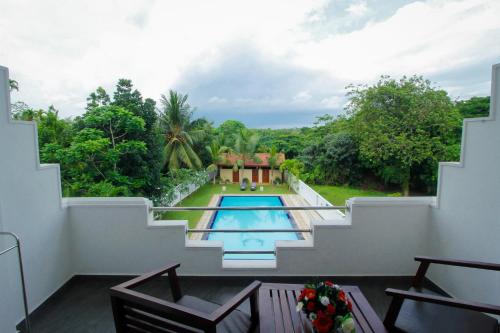 a view from the balcony of a villa with a swimming pool at Rockery Villa Ayurveda in Bentota